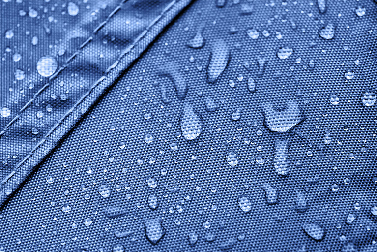 A close-up of a tent side wall on which water beads form due to the lotus effect.