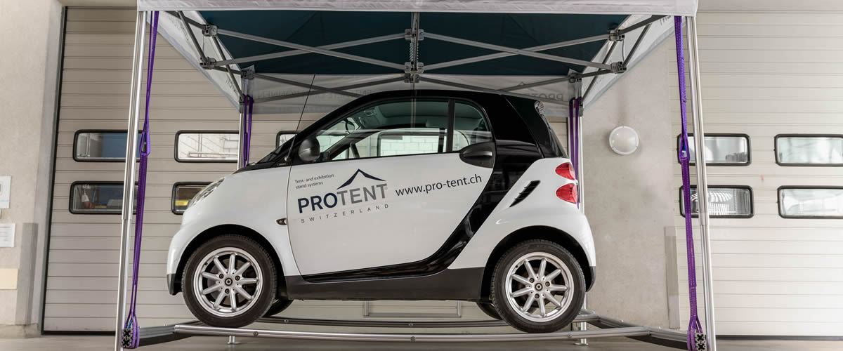 A Smart Fortwo suspended in a Pro-Tent folding pavilion.