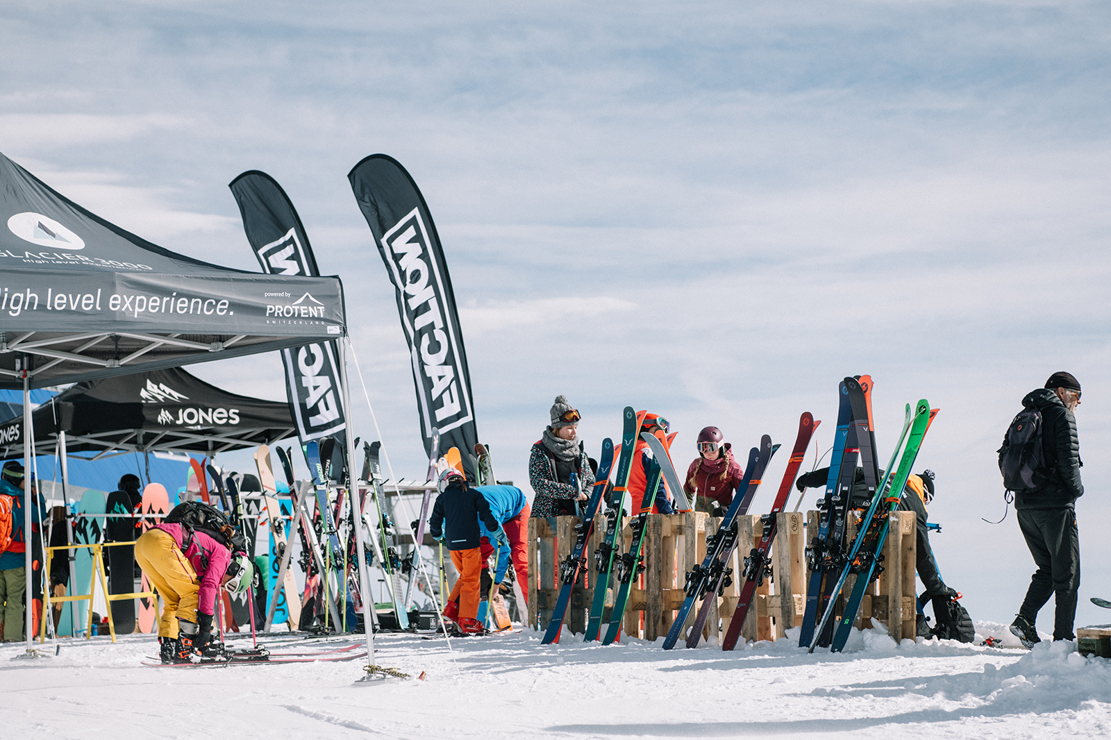Skiers stand in front of Pro-Tent folding tents.