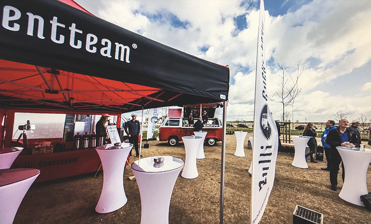 A catering stand by the Bulli Event Team with bar tables, folding tent and bar.