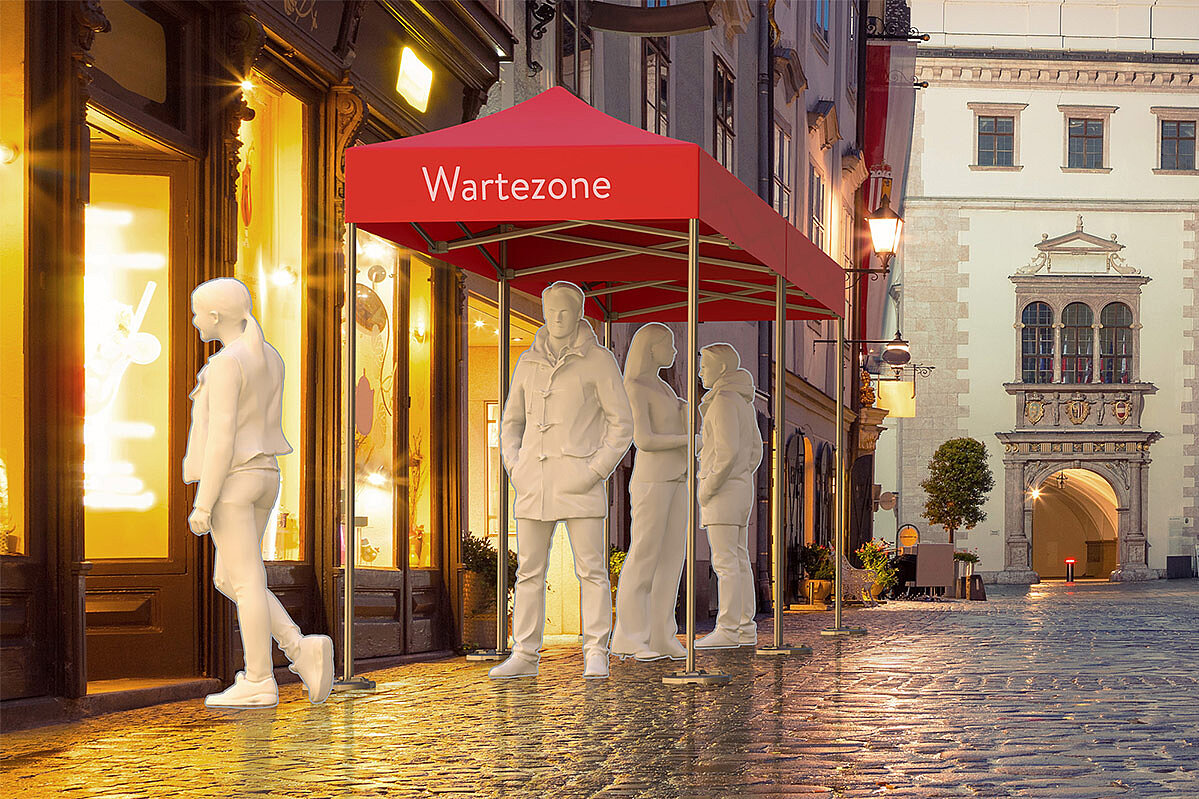 A waiting zone controls the flow of visitors in front of a shop.