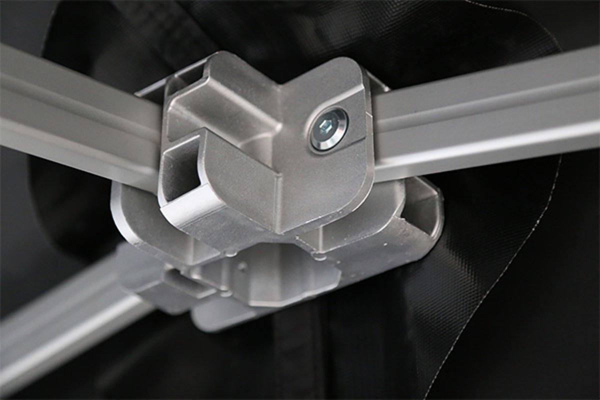 A close-up of a design connector in the folding tent frame of a Pro-Tent folding pavilion.
