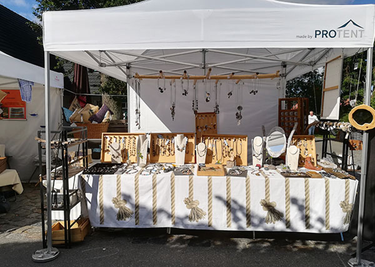 A market tent from Pro-Tent being used as a sales stand for handmade jewellery.