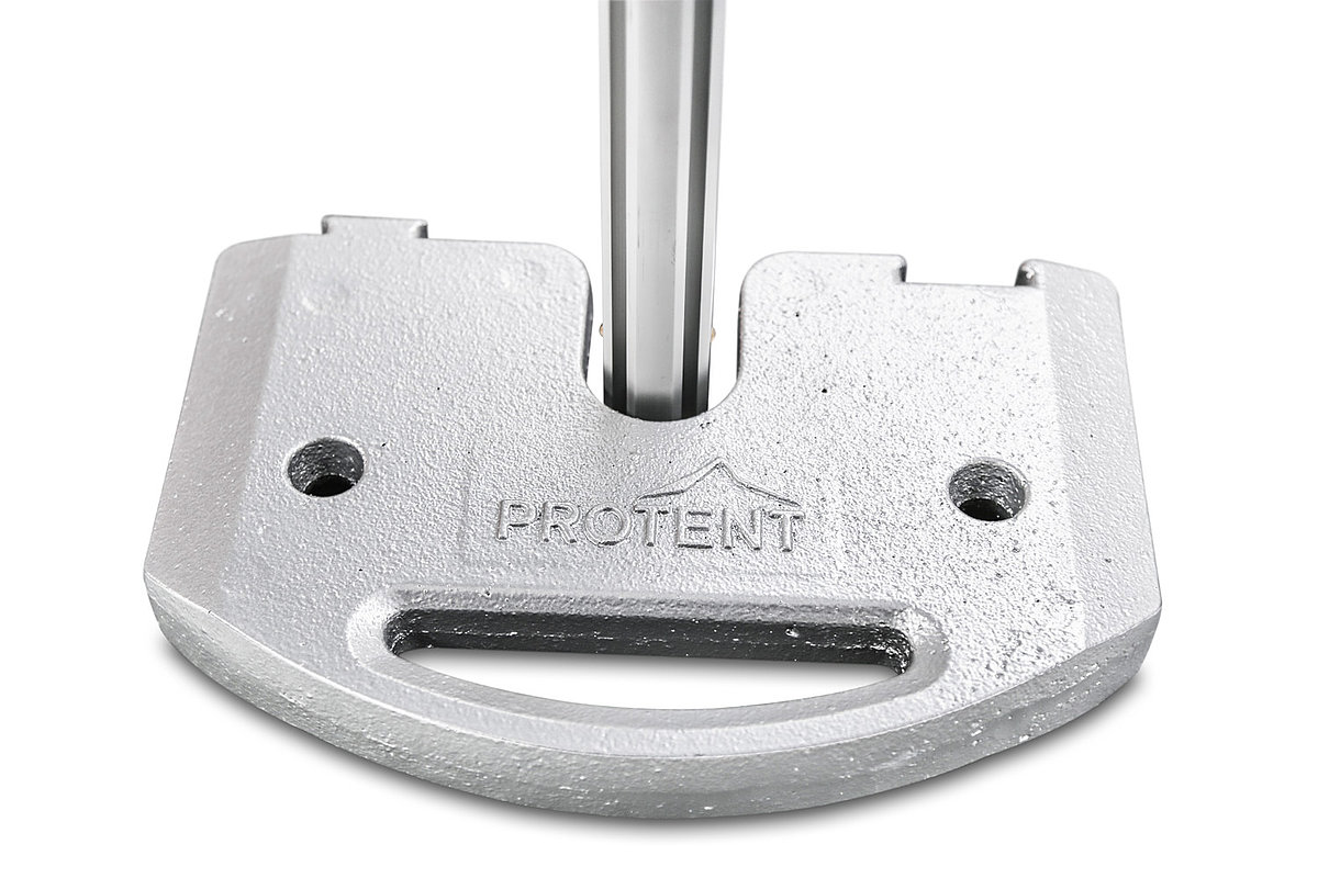A 15 kg weight plate holds down the foot of a Pro-Tent assembly tent.