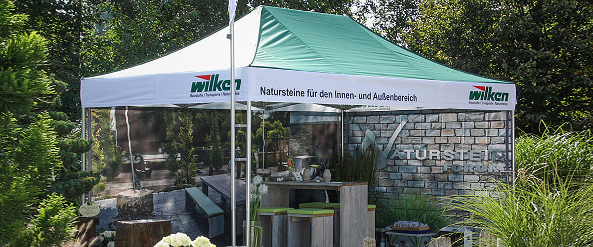 A folding tent from a natural stone company with printed side walls.