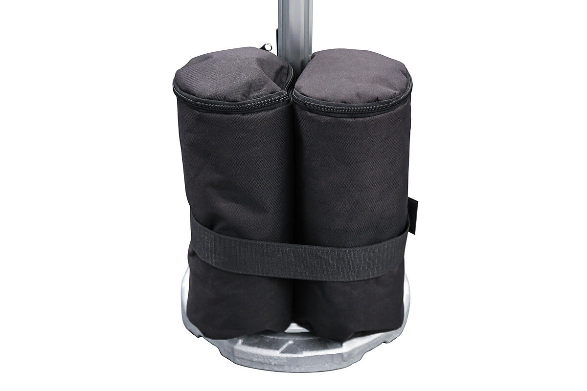 A 10 kg sand weight weighs down a tent stand
