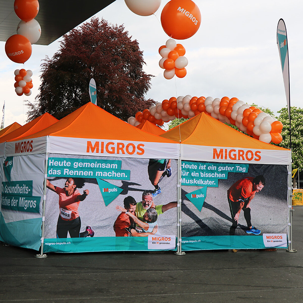 Two City of Zurich tents being used as information stands at an event.